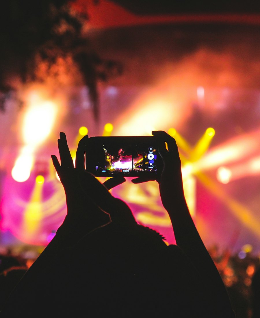 A festival-goer filming the stage on their phone