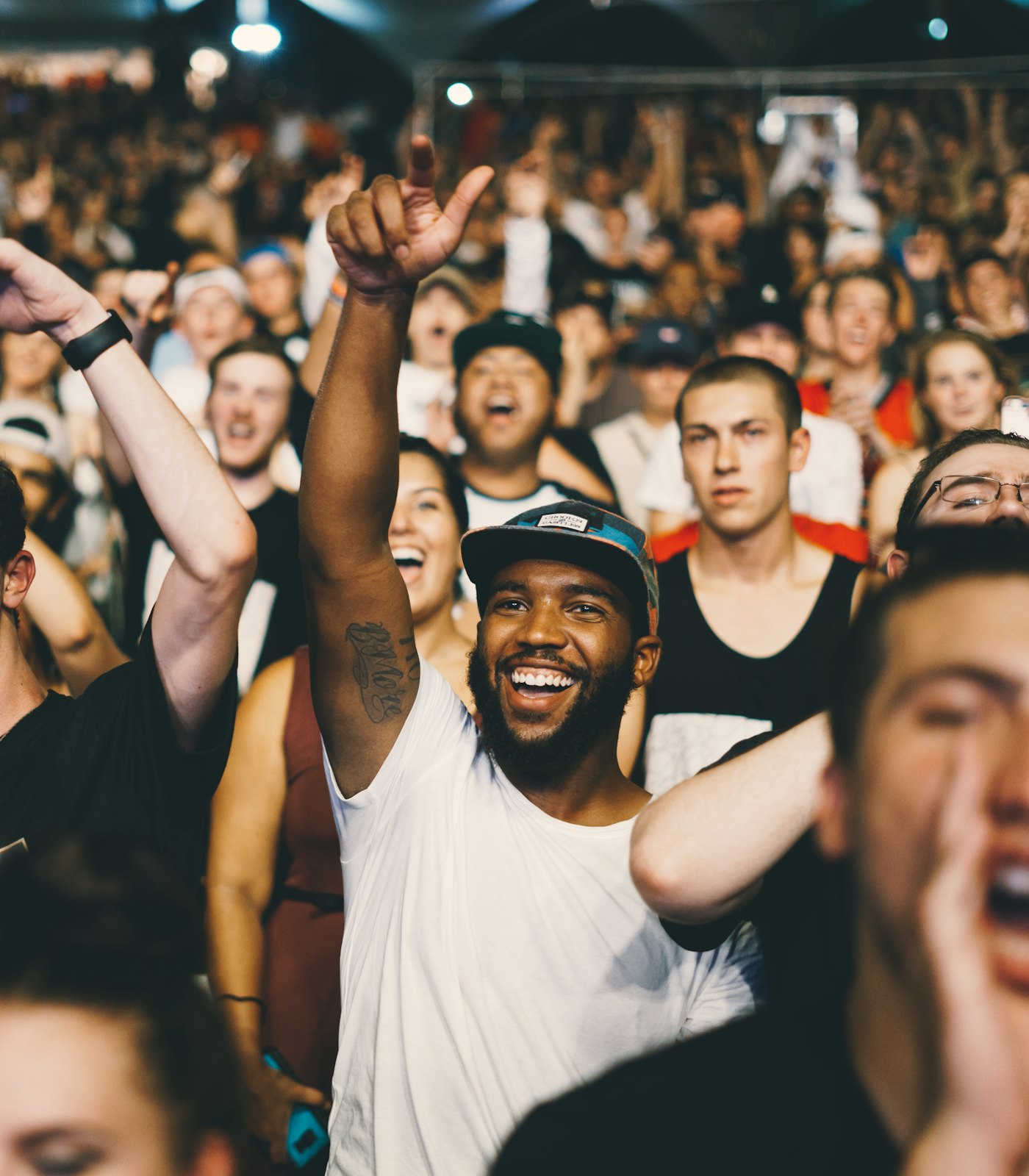 A crowd of fans cheering at a gig